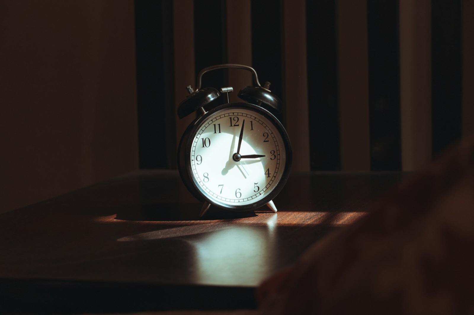 An alarm clock on a table at night