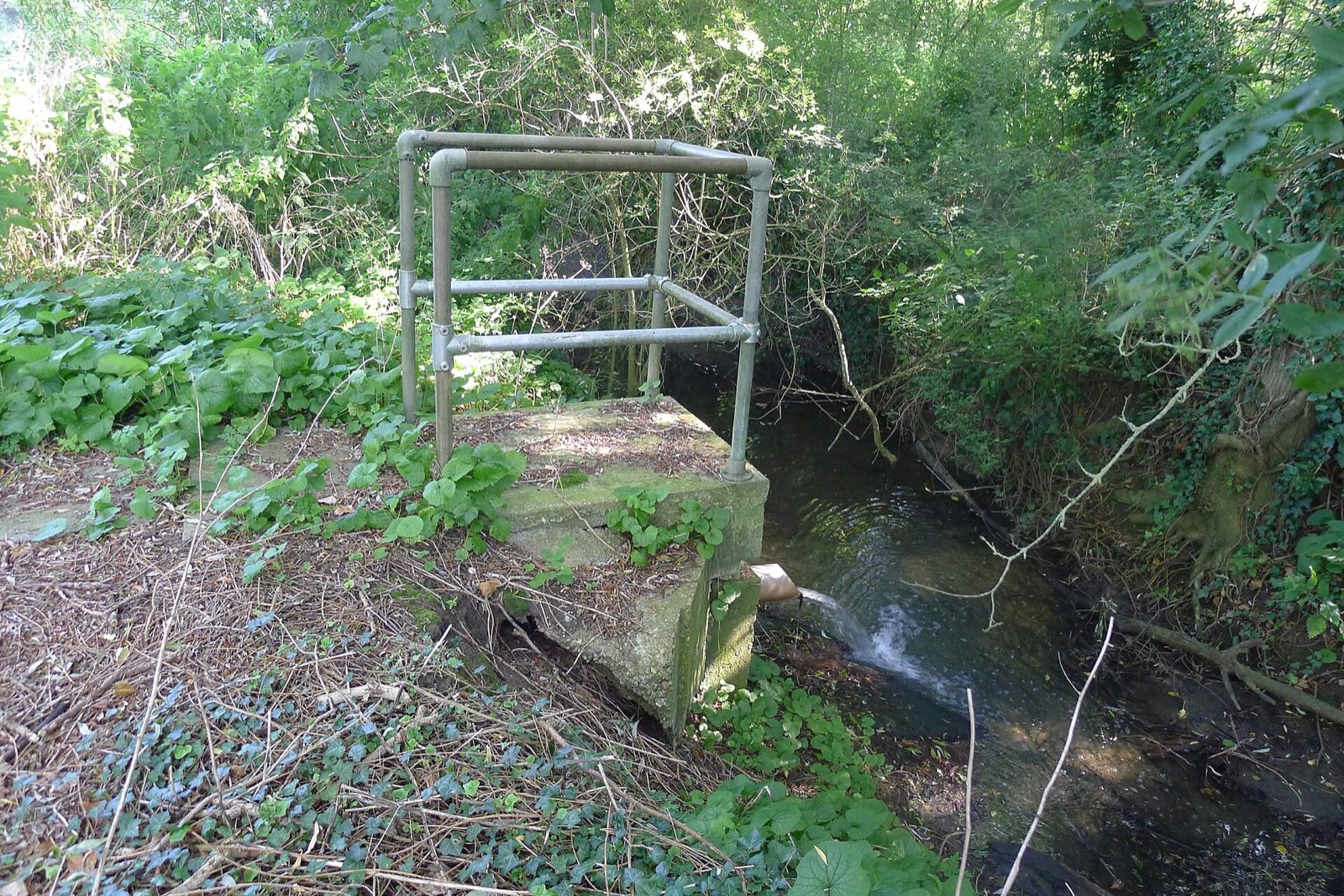 A pipe discharging into a river
